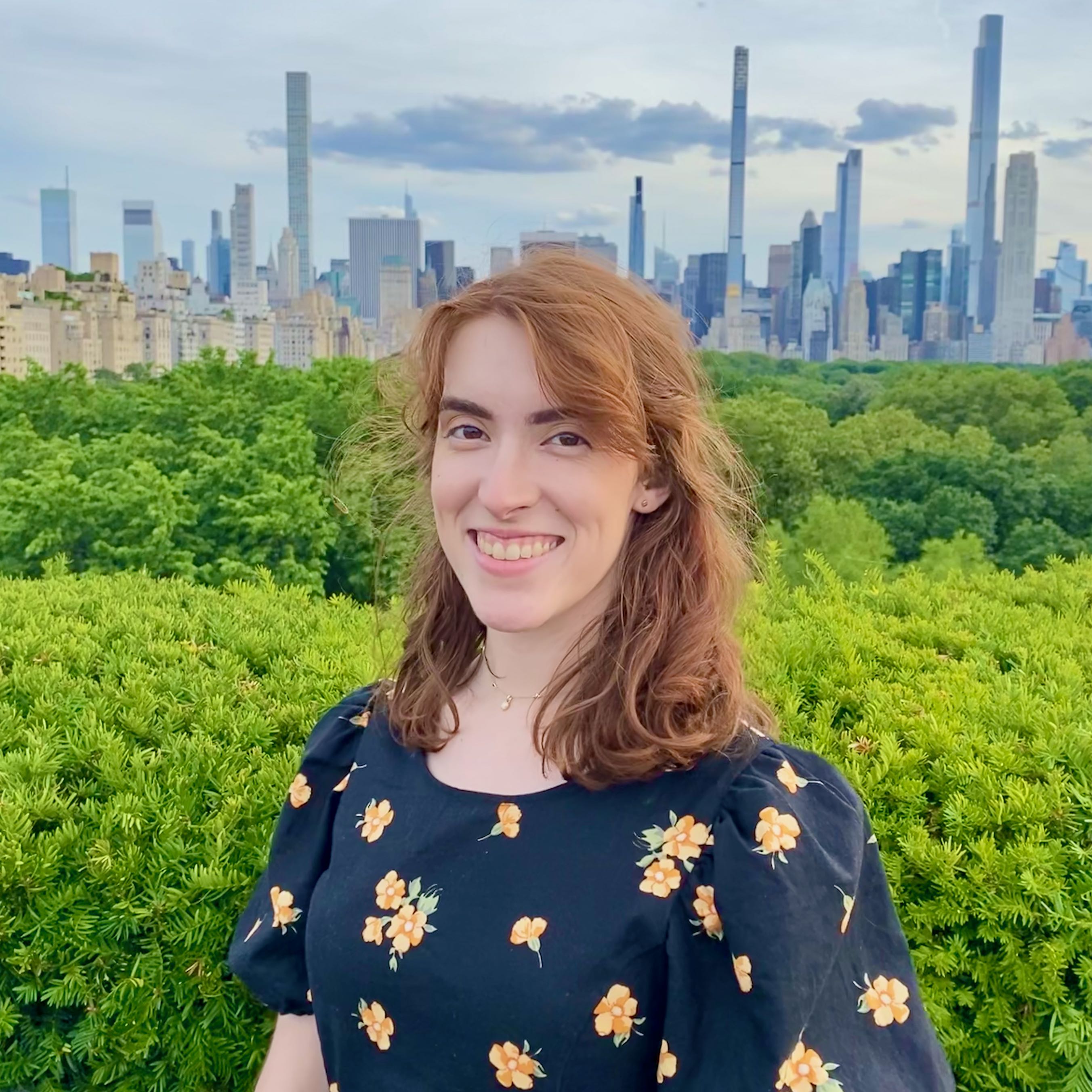 picture of Claire Riggs in front of the New York skyline